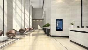 A large wall-mounted screen displays a welcome message: Welcome to 101 Park Ave Appspace HQ, with blue menu options for About Appspace, Case Studies, Company News, and Digital Workspaces below.