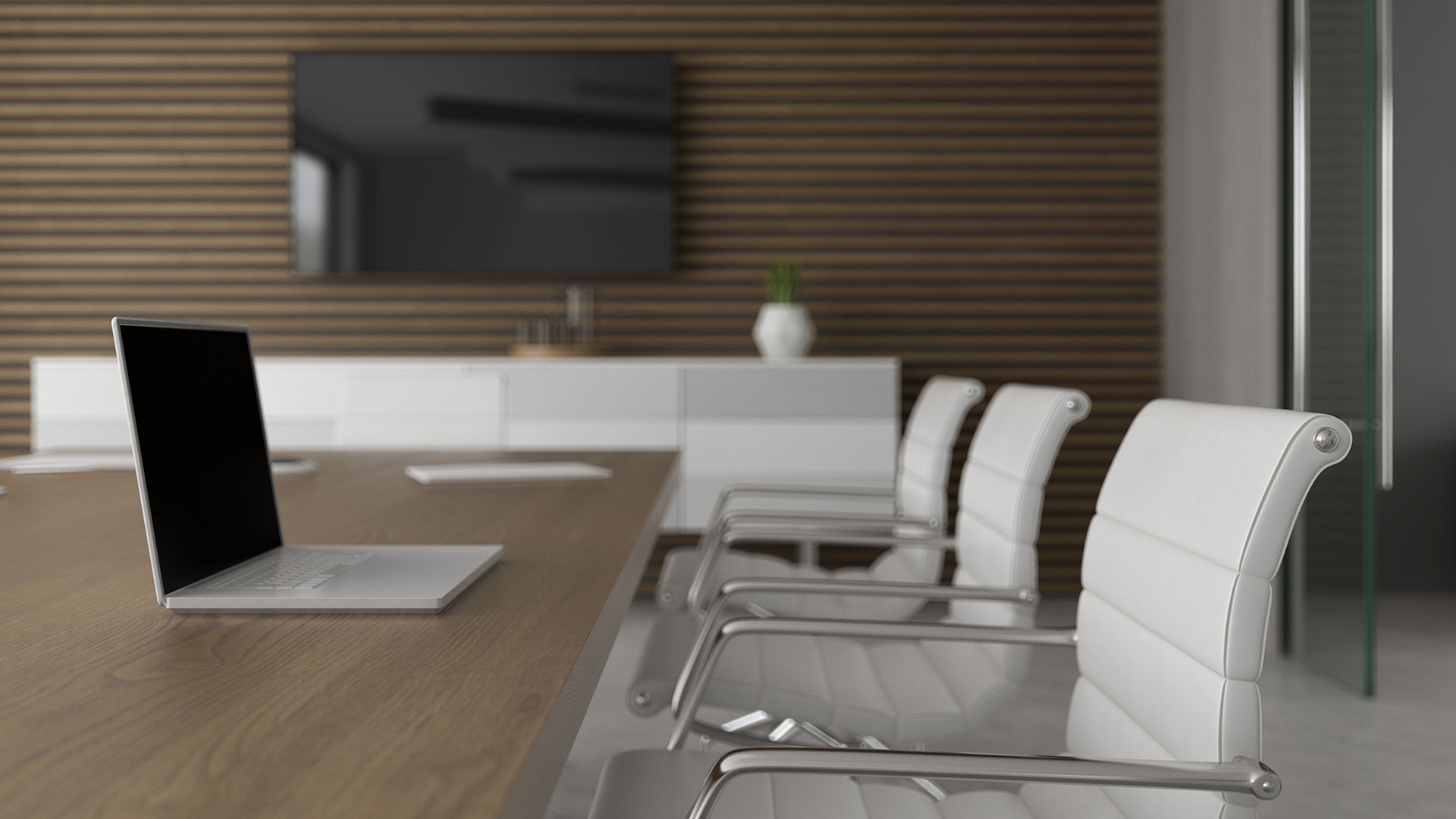 Modern meeting room with a large display screen and conference table.