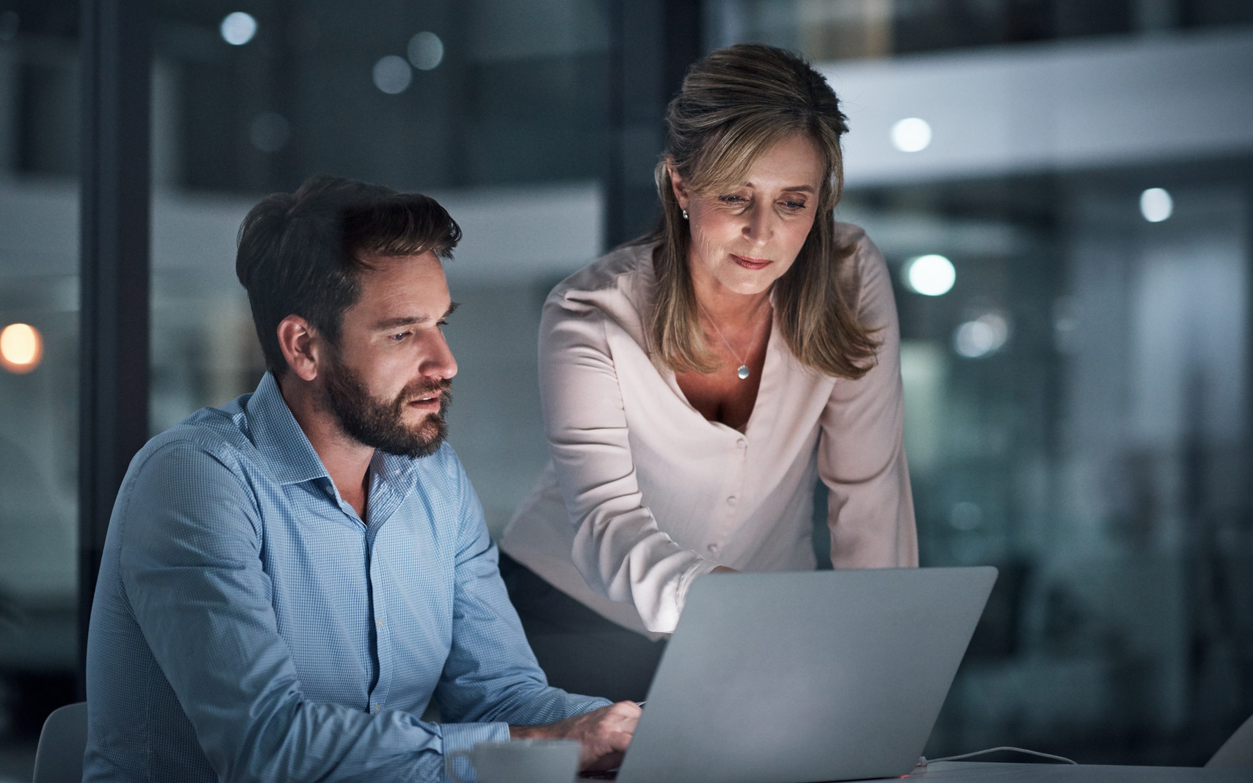 2 people working on a laptop